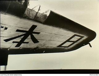 Wagga, NSW. c 1947. The outer section of the port (left hand) wing of a Beaufort bomber aircraft showing Japanese Kanji characters painted on the underside of the wing. The message was painted from ..