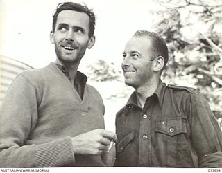 1942-12-01. PAPUA. GEOFF READING (DAILY MIRROR, SYDNEY) AND FRANK BAGNALL (DEPARTMENT OF INFORMATION) CAMERA-MAN). THIS PICTURE WAS TAKEN SHORTLY AFTER THEY REACHED LAND AFTER THE SHIP IN WHICH ..