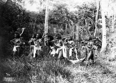 Fijian men posed with captured prisoner. "Vanquished"