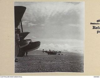 JACQUINOT BAY, NEW BRITAIN. 1945-04-09. THE RAAF LIBERATOR, CARRYING SENATOR J.M. FRASER, ACTING MINISTER FOR THE ARMY, AND OFFICIAL PARTY, TAKING OFF FROM JACQUINOT BAY AIRSTRIP