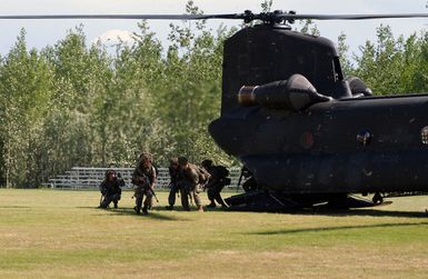 US Marine Corps (USMC) Marines from Marine Security Element (MSE), India Company (I CO), 3rd Battalion (BN), 3rd Marines, Marine Corps Base Hawaii (MCBH) Kaneohe Bay, Hawaii (HI), debark a US Army (USA) CH-47D Chinook, Bravo Company (B CO), 4th Battalion, 123rd Theater Aviation (4-123rd Aviation Regiment), Fort Wainwright Army Post, Alaska (AK), during Military Operations in Urban Terrain (MOUT) training as part of Exercise NORTHERN EDGE 04. The training is taking place at the combat town training area on Fort Wainwright Army Post, AK. NORTHERN EDGE is Alaska's annual joint training exercise designed to enhance interoperability among the services by sharpening and honing joint service...