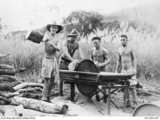 WARDS STRIP, PORT MORESBY, NEW GUINEA, 1943-03. FOUR MEMBERS OF THE RAAF CUT A LOG ON A CIRCULAR SAW. WARDS AERODROME WAS WORKED ON BY BOTH NO. 2 AND NO. 5 MOBILE WORKS SQUADRON (LATER AIRFIELD ..