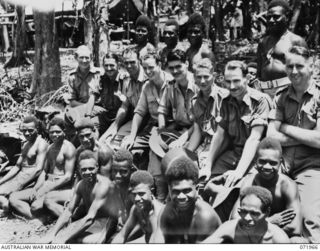 SONG RIVER AREA, NEW GUINEA. 1944-03-31. MEMBERS OF C COMPANY, PAPUAN INFANTRY BATTALION WATCHING A SPORTS EVENT. IDENTIFIED PERSONNEL ARE: SX6600 SERGEANT D.A. WILLIAMS (1); VX39091 SERGEANT R.H. ..