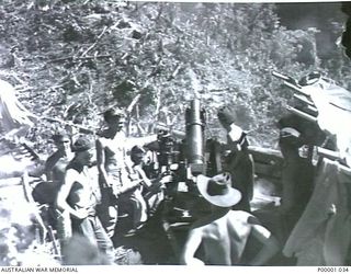 THE SOLOMON ISLANDS, 1945-01-12. AN AIF 25 POUND GUN CREW READY FOR ACTION. (RNZAF OFFICIAL PHOTOGRAPH.)