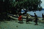 Carrying canoe ashore, Rabaul Harbour