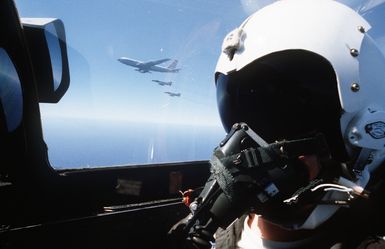 A view from the cockpit of a 199th Tactical Fighter Squadron, Hawaii Air National Guard, F-4 Phantom II aircraft as two other F-4s form up near a 161st Air Refueling Group KC-135 Stratotanker aircraft for aerial refueling