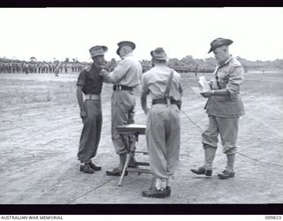 RABAUL, NEW BRITAIN, 1946-02-14. MAJOR GENERAL K.W. EATHER, GENERAL OFFICER COMMANDING 11 DIVISION, PRESENTING THE MILITARY CROSS TO LIEUTENANT J.C. WARD, 2 NEW GUINEA INFANTRY BATTALION, DURING A ..