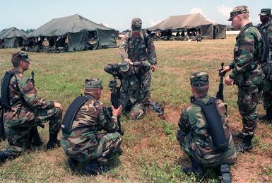 US Army (USA) Soldiers assigned to A/Company, 1ST Battalion, 17th Infantry Division attend a class on search and control of suspect techniques near the Tent City living facilities at Orote Point, Guam during Exercise TANDEM THRUST '99