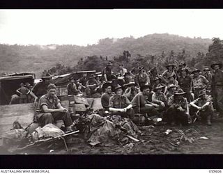 LANGEMAK AREA, NEW GUINEA. 1943-11-02. TROOPS OF THE 4TH AUSTRALIAN FIELD AMBULANCE AND THE 4TH AUSTRALIAN INFANTRY BRIGADE RESTING ON THE BEACH AT SIMBANG