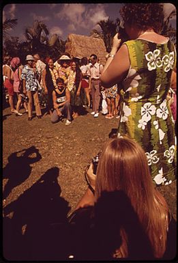 TOURISTS AT A HULA DANCE DEMONSTRATION