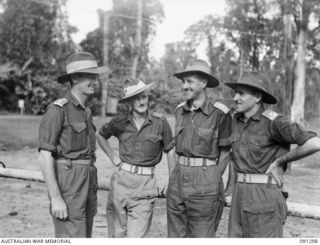 Lieutenant Colonel (Lt Col) J G McKinna, 25th Infantry Battalion, with Officers of the Battalion Headquarters. Identified personnel are (left to right) Chaplain B Cahill; Major W J E Jackson; Lt ..