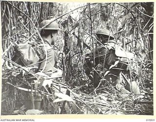 1943-10-06. NEW GUINEA. ATTACK ON LAE. THIS PLATOON OF A FAMOUS AUSTRALIAN BATTALION TOOK PART IN THE VICTORIOUS ADVANCE ON LAE. W. PECOCK OF ROLLESTON, QUEENSLAND AND SGT. J. EVANS OF BONDI, ..