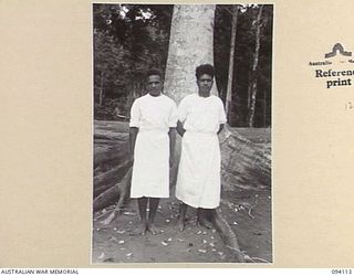 POPONDETTA, NEW GUINEA, 1945-07-02. NATIVE MEDICAL ORDERLY J. DOW WHO IS IN CHARGE OF NATIVE MEDICAL ORDERLIES (1), WITH NATIVE MEDICAL ORDERLY D. NOUAIRI (2), WHO HAS COMPLETED TWO YEARS OF ..