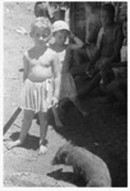 Lauren and Felicia Keesing with Kwaio people and a small pig