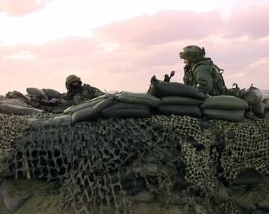 SRA Edward Jones (left) and SRA Tara Corse both assigned to the 15th Security Forces Squadron, Hickam Air Force Base, Hawaii, post sentry duty overlooking the Kunsan Air Base perimeter Oct. 27, 1998. Both airman and several other Air Force personnel are at Kunsan Air Base participating in Foal Eagle '98