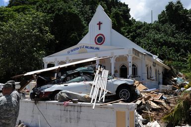 Earthquake ^ Tsunami - Leone, American Samoa, October 2, 2009 -- Debris of every kind is spread across the yard of a church. The power of the recent tsunami is demonstrated by this car which was pushed uphill to the front of a church.