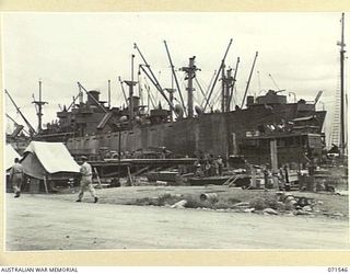 LAE, NEW GUINEA. 1944-03-23. THE WATERFRONT AT HEADQUARTERS LAE BASE SUB-AREA, VIEIWING NO 1 LIBERTY WHARF, THE FIRST WHARF BUILT AFTER THE RECAPTURE OF LAE. THE WATER TRANSPORT CONTROL TENT STANDS ..