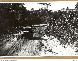 FINSCHHAFEN AREA, NEW GUINEA. 1943-11-09. PARTIALLY MADE ROAD FROM LANGEMAK BAY TO DREGER HARBOUR WHICH RUNS PARALLEL WITH THE EASTERN END OF THE NEW BOMBER AIRSTRIP BEING BUILT JOINTLY BY THE ..