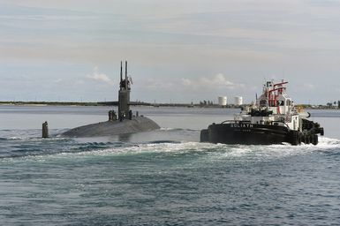 The US Navy (USN) Los Angeles Class Attack Submarine USS SAN FRANCISCO (SSN 711) departs its former homeport of Apra Harbor, Guam, escorted by the Goliath a tug based at Piti Guam, for its journey across the Pacific Ocean to her new homeport of Bremerton, Washington (WA). The SAN FRANCISCO was part of Submarine Squadron 15 operating from the Mariana Islands