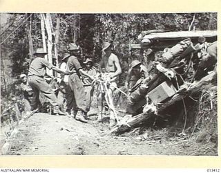 PAPUA. 1942-10-09. REPORTS FROM NEW GUINEA TELL OF THE SPLENDID PART PLAYED BY AUSTRALIAN ARTILLERY UNITS IN RECENT OPERATIONS AGAINST THE JAPANESE. THIS PICTURE GIVES SOME INDICATION OF THE ..