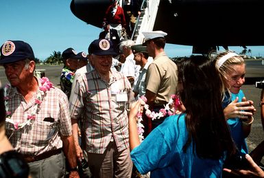 World War II China-Burma-India Veterans arrive on the first leg of their 32,000 mile journey of memories to commemorate the China-Burma-India Theater. The veterans arrived on a KC-10 from Travis AFB, CA and are greeted in Hawaii by local children who present each vet with an Hawaiian style laye. Pictured (left to right) MAJ. GEN. (USAF Ret) Eugene Sterling, COL. (USAF Ret) Joseph B. Shupe