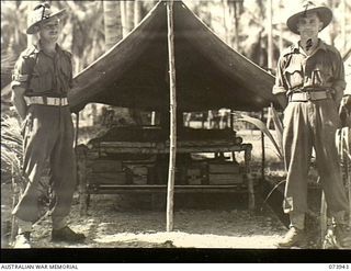 MADANG, NEW GUINEA. 1944-06-17. VX69908 SERGEANT L. C. WINDLEY (LEFT) AND V45100 SERGEANT A. T. JOHANNESEN OUTSIDE A "MODEL" LAIDOUT TENT AT C COMAPNY, 58/59TH INFANTRY BATTALION. THE UNIT IS ..