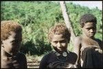 Boy and two girls, girl in middle with girimalaile clamshell pendant necklace