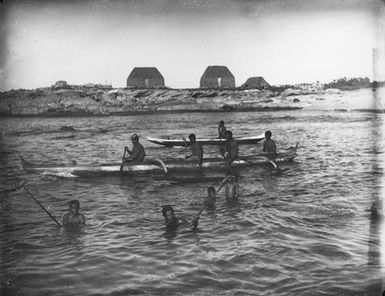 Hawaiian Islands, outrigger canoes and men fishing