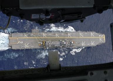 An overhead view of the US Navy (USN) Tarawa Class Amphibious Assault Ship USS SAIPAN (LHA 2) taken from a USN MH-60S Seahawk helicopter as it flies over the ship. The SAIPAN is currently underway in the Atlantic Ocean en route to her new homeport of Norfolk, Virginia (VA), after a successful 91-day deployment in support of the Global War on Terrorism (GWOT). (SUBSTANDARD)