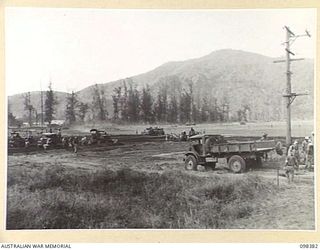 RABAUL, NEW BRITAIN. 1945-10-27. JAPANESE WORKING PARTIES, GRADERS AND BULLDOZERS BUSILY ENGAGED ON THE PREPARATION OF THE DIVISIONAL PARADE GROUND IN WHAT WAS ONCE THE MAIN PART OF RABAUL ..