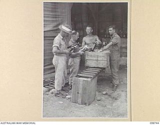 BORAM, NEW GUINEA. 1945-11-16. PERSONNEL FROM 3 BASE SUB AREA, AUSTRALIAN ARMY CANTEENS SERVICE, CHECKING OUT THE WEEKLY ISSUE OF BEER TO ONE OF THE UNITS IN THE AREA. IDENTIFIED PERSONNEL ARE:- ..