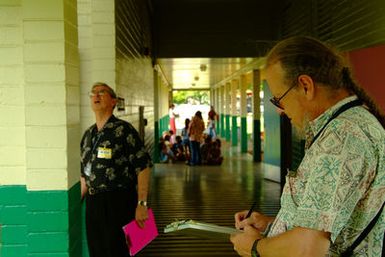 [Earthquake] Kalani, HI, October 27, 2006 - FEMA Public assistance Officer Harry Sherwood conducts a preliminary damage assesment at Kailua Elementary School with Civil Defense Planner Robert Hutto after a recent earthquake to inspect the structures for damage. Adam DuBrowa/FEMA.