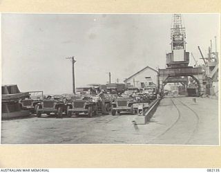 TOWNSVILLE, QLD. 1944-10-18. TRANSPORT OF FIRST ARMY IN THE MARSHALLING YARD AWAITING EMBARKATION TO NEW GUINEA ABOARD THE LIBERTY SHIP SS JAMES OLIVER