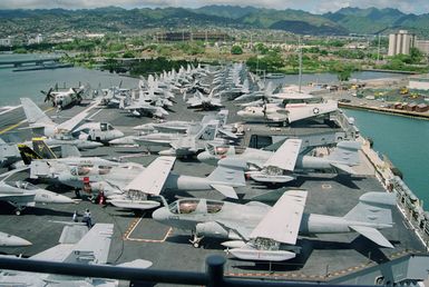 View from pri-fly (Primary Flight Control), looking forward on the flight deck of the nuclear-powered aircraft carrier USS ABRAHAM LINCOLN (CVN 72). Aircraft on deck include F/A-18C Hornet aircraft of VFA-113, VFA-115 and VFA-25; EA-6B Prowler aircraft of Tactical Electronic Warfare Squadron One-Three-Nine (VAQ-139); S-3A Viking aircraft; E-2C Hawkeye and a C-2A Greyhound COD (Carrier On-Board delivery) aircraft. The LINCOLN is here to take part in Operation RIMPAC 2000