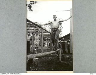 1943-06-26. NEW GUINEA. SGT. I. NIXON, OF ARMIDALE, N.S.W. WALKS THE SWEDISH BOOM TO RESTORE NERVE CONTROL AND BALANCE. (NEGATIVE BY N. BROWN)