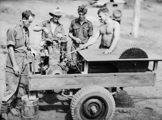 LAE, NEW GUINEA. 1944-10-03. PERSONNEL OF NO.1 PLATOON, 12TH FIELD COMPANY, PREPARING TO, LOAD THEIR PORTABLE SAWBENCH ON TO A TRUCK FOR TRANSPORT TO A NEW OPERATIONAL AREA. IDENTIFIED PERSONNEL ..