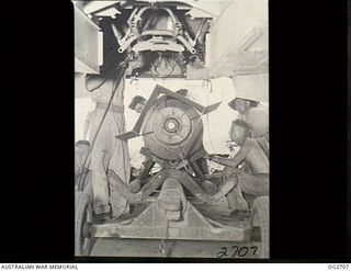 VIVIGANI, GOODENOUGH ISLAND, PAPUA. 1943-11-17. ARMOURERS LOADING A 2000LB DAISY-CUTTER BOMB INTO A BEAUFORT BOMBER AIRCRAFT OF NO. 8 SQUADRON RAAF IN READINESS FOR THE HEAVY ALL-AUSTRALIAN ..