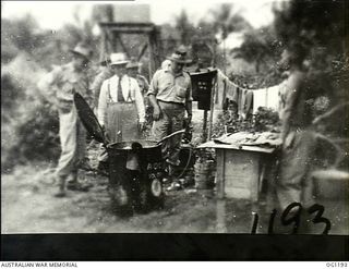 AITAPE, NORTH EAST NEW GUINEA. C. 1944-06. ARTHUR DRAKEFORD, THE MINISTER FOR AIR, ACCOMPANIED BY AIR COMMODORE F. R. W. SCHERGER, THE AIR OFFICER COMMANDING NO. 10 GROUP RAAF, AND OTHER RAAF ..