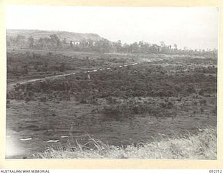 WEWAK AREA, NEW GUINEA, 1945-05-30. THE VIEW FROM MISSION HILL SHOWING THE PARTLY CONSTRUCTED ROAD AND WORK BEING CONTINUED ON THE WEWAK AIRSTRIP. WEWAK POINT AND VARIOUS CAMPS LIE IN THE ..