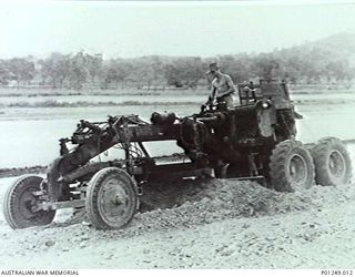 WARDS STRIP, PORT MORESBY, NEW GUINEA, 1943-03. A GRADER FROM NO. 5 AIRFIELD CONSTRUCTION SQUADRON RAAF AT WORK. ORIGINAL PRINT RAAF OFFICIAL PHOTO GA1/2 62, 90G. (DONOR G. CREAGH)