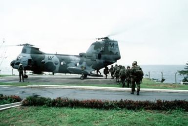 A squad of Marines boards a Marine Medium Helicopter Squadron 261 (HMM 261) CH-46E Sea Knight helicopter on the grounds of the US Embassy. Marines of the 22nd Marine Expeditionary Unit (22nd MEU), deployed aboard the amphibious assault ship USS SAIPAN (LHA 2), were sent to augment security at the embassy as part of Operation SHARP EDGE