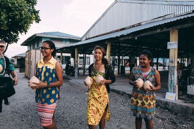 Locals bringing coconut drinks, Nukunonu, Tokelau