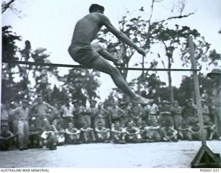 THE SOLOMON ISLANDS, 1945-01-12. A SUCCESSFUL HIGH JUMP AT A COMBINED ANZAC SPORTS MEETING AT BOUGAINVILLE ISLAND. (RNZAF OFFICIAL PHOTOGRAPH.)