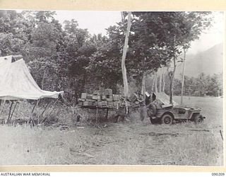 GOODENOUGH ISLAND, NEW GUINEA. 1942-10. TROOPS WORKING AT AN IMITATION STORES DUMP WITH EMPTY BOXES. THIS WAS PART OF A MASTERPIECE OF BLUFF AND DECEPTION, BY WHICH, THE SMALL GROUP OF AUSTRALIANS ..