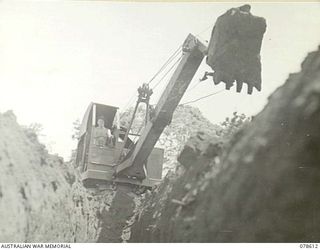 CAPE CUNNINGHAM, NEW BRITAIN. 1945-01-22. A MECHANICAL SCOOP OF THE 2/ 3RD RAILWAY CONSTRUCTION COMPANY BEING USED TO DIG A DRAINAGE DITCH ACROSS THE NEW AIRSTRIP