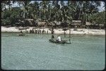 Kaileuna Island: village houses, people gathered on beach, Edwin Hutchins (in white shirt) on canoe