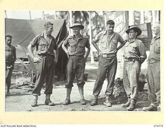 MILILAT, NEW GUINEA. 1944. SALVATION ARMY PERSONNEL OUTSIDE THE RECREATION HUT WHICH IS RUN JOINTLY BY THE SALVATION ARMY AND THE AUSTRALIAN COMFORTS FUND AT HEADQUARTERS, 5TH DIVISION