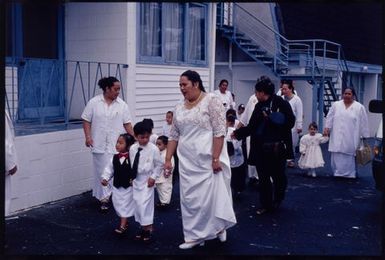 Children and their Sunday school teachers walking to church on White Sunday