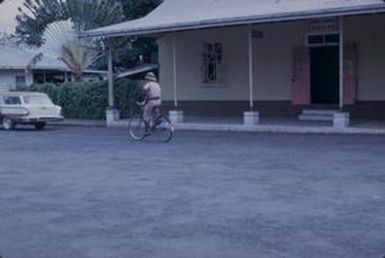 [Man riding bicycle in American Samoa]