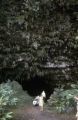 French Polynesia, people standing outside cave opening in Papeete